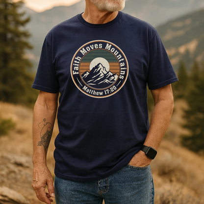 Bearded man in a Faith Moves Mountains T-Shirt with mountain graphic, standing outdoors. The shirt, made of soft cotton, highlights adventure spirit and durability, perfect for nature enthusiasts.