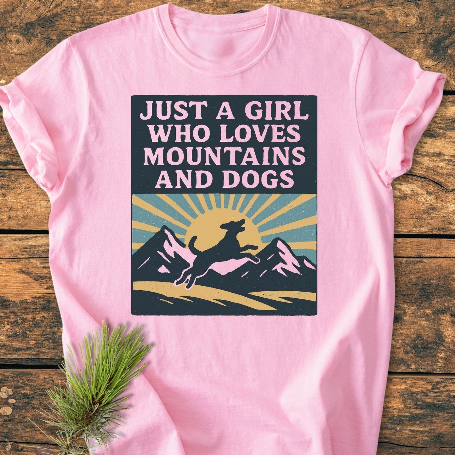 Just A Girl Who Loves Dogs - Vintage Wash Tee: Light-pink T-shirt with mountain and dog graphic, rustic pine sprig. Cozy, relaxed fit, durable, made from soft-washed 100% ring-spun cotton.