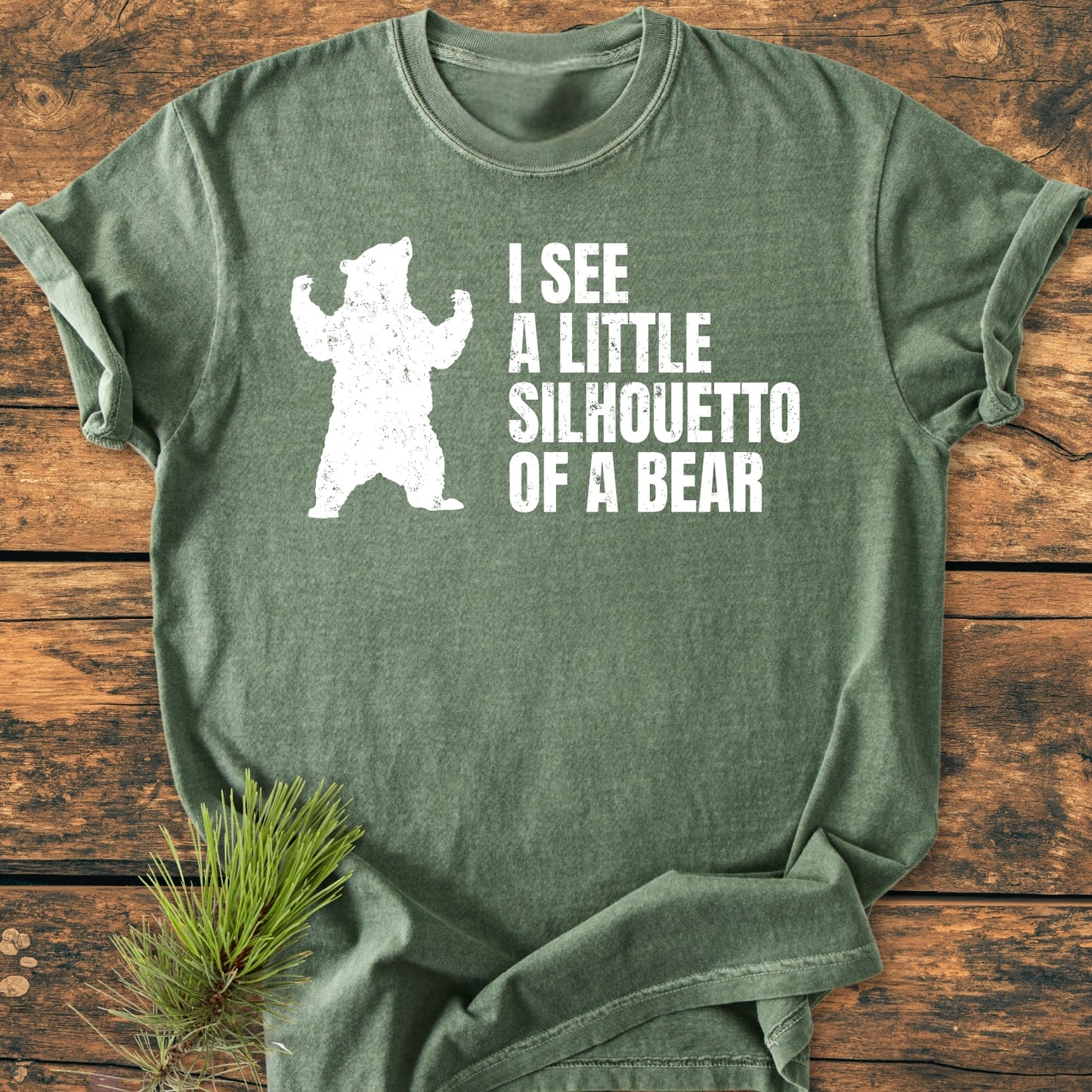 I See A Little Silhouetto Of A Bear - Vintage Wash Tee displayed on wood, featuring a white bear silhouette and playful text on soft, relaxed fit 100% ring-spun cotton garment-dyed fabric.