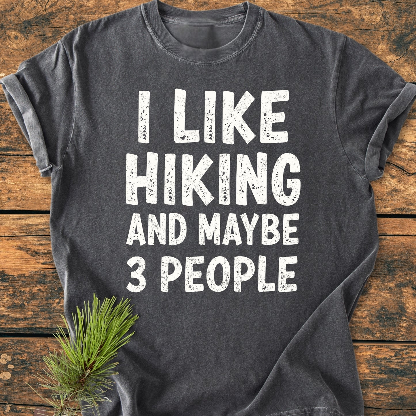 Charcoal-gray I Like Hiking And Maybe 3 People - Vintage Wash Tee with white distressed lettering on a wooden surface, featuring a soft, relaxed fit and durable stitching.