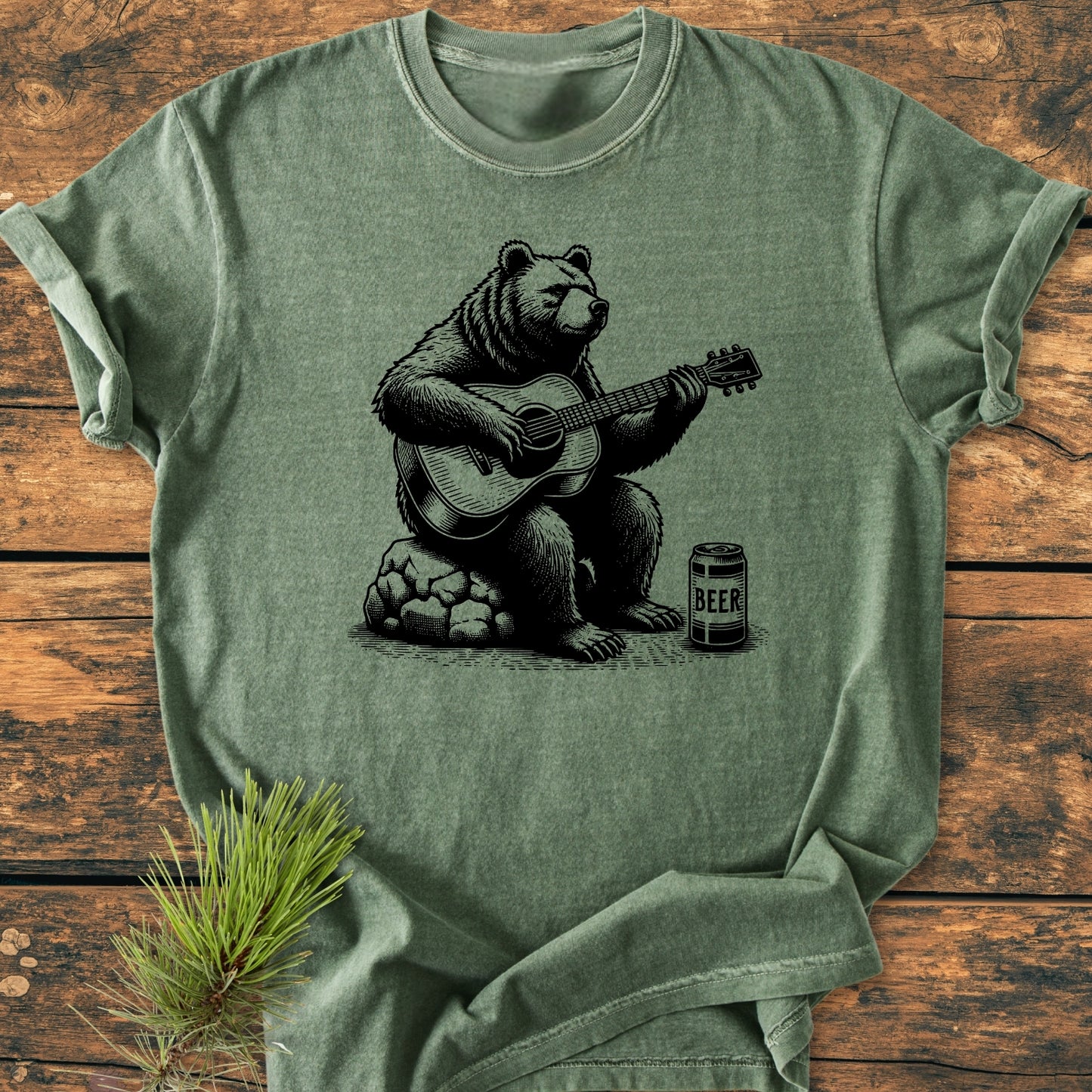 Bear Playing Guitar - Vintage Wash Tee laid flat, featuring a bear strumming a guitar with a beer can beside it. Made from garment-dyed, soft-washed 100% ring-spun cotton for comfort and durability.