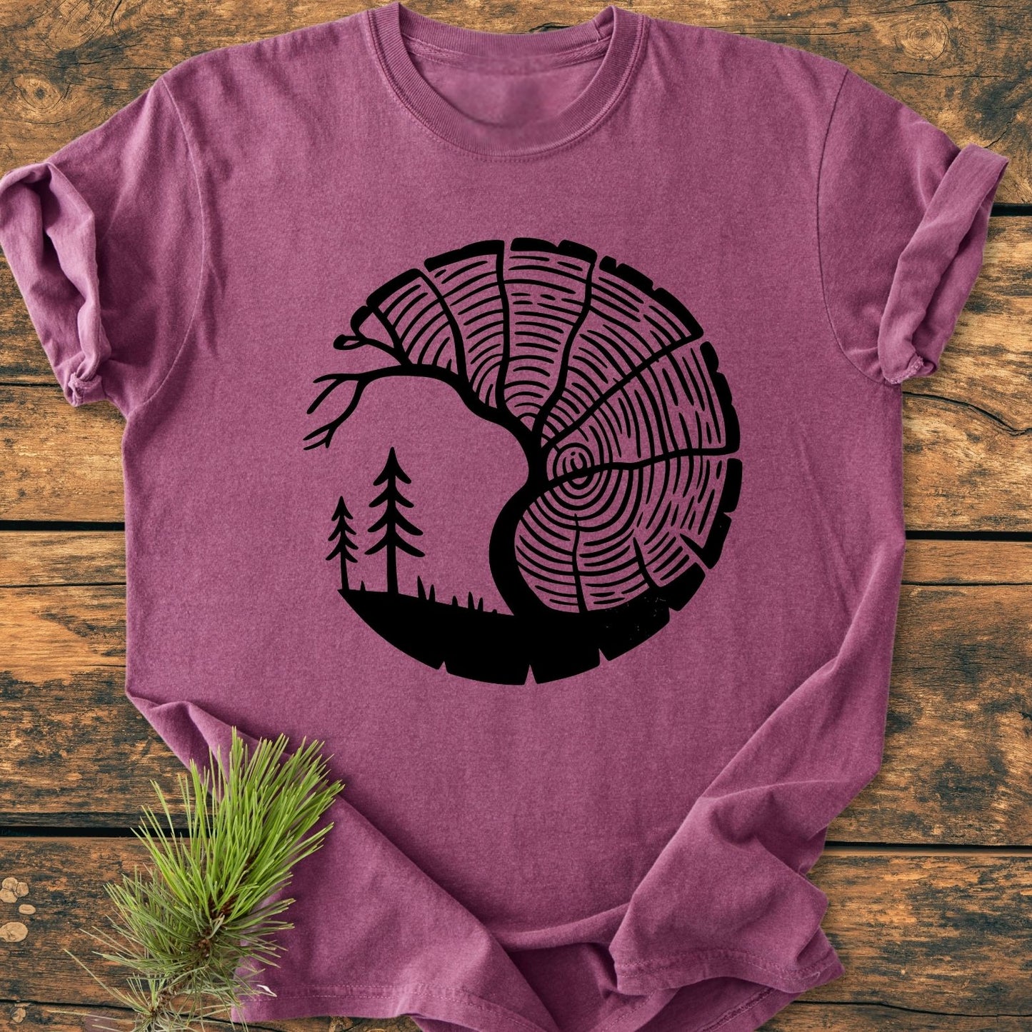 Tree Lover - Vintage Wash Tee features a heather-purple design with a stylized tree-ring and forest print, laid on wood. Made from 100% ring-spun cotton, offering a soft, relaxed fit.