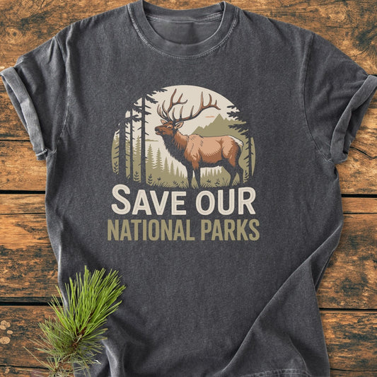Save Our National Parks - Vintage Wash Tee features a bull elk in a scenic print, laid on a table with a sprig. Crafted from soft, pre-shrunk, ring-spun cotton for comfort and durability.