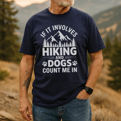 Man outdoors wearing the Hiking And Dogs T-Shirt with a mountain and paw print design, expressing a love for hiking and dogs. Casual style with jeans and a smartwatch.