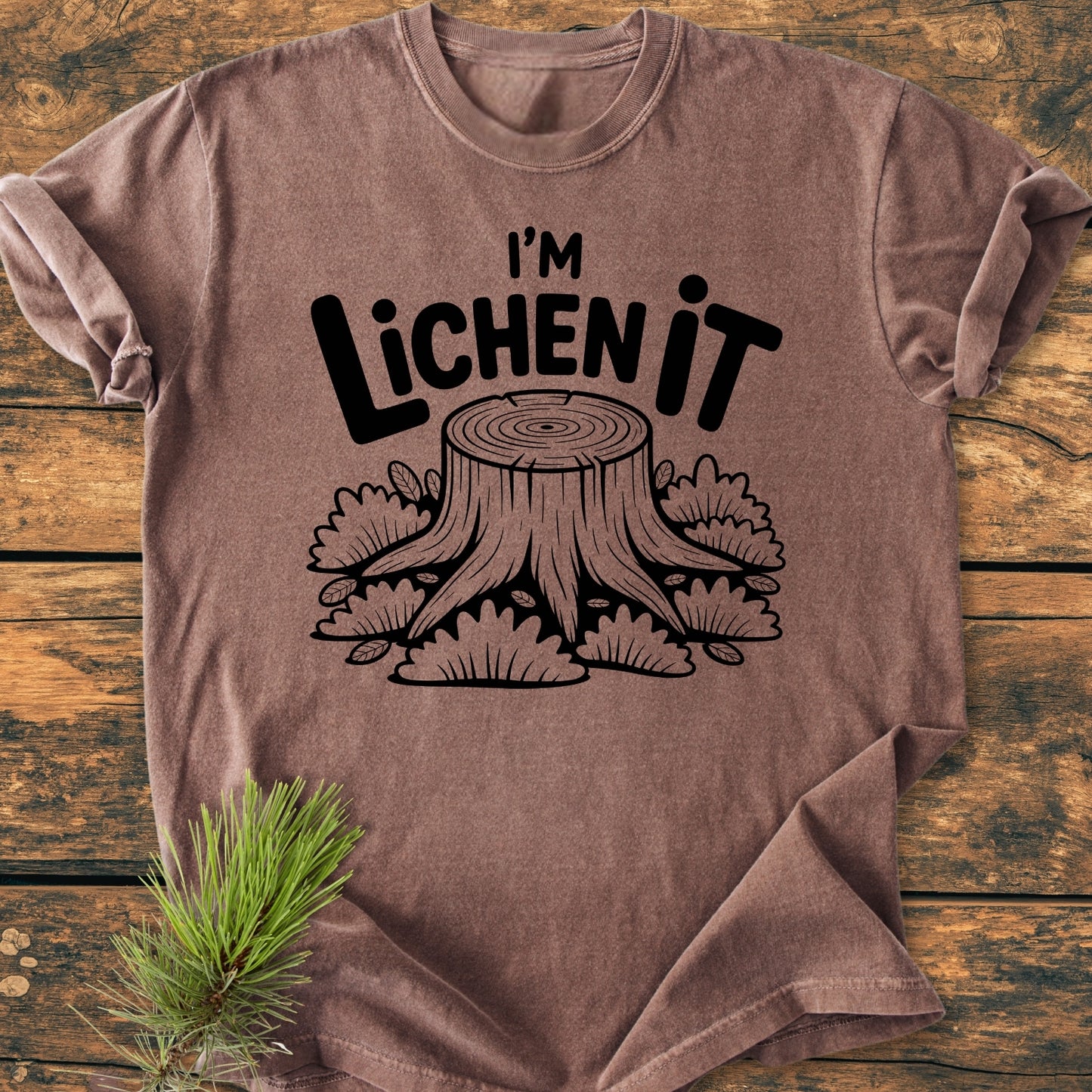 I'm Lichen It - Vintage Wash Tee features a stylized tree stump and foliage print on a soft, relaxed-fit brown T-shirt, crafted from durable, garment-dyed, 100% ring-spun cotton for daily comfort.
