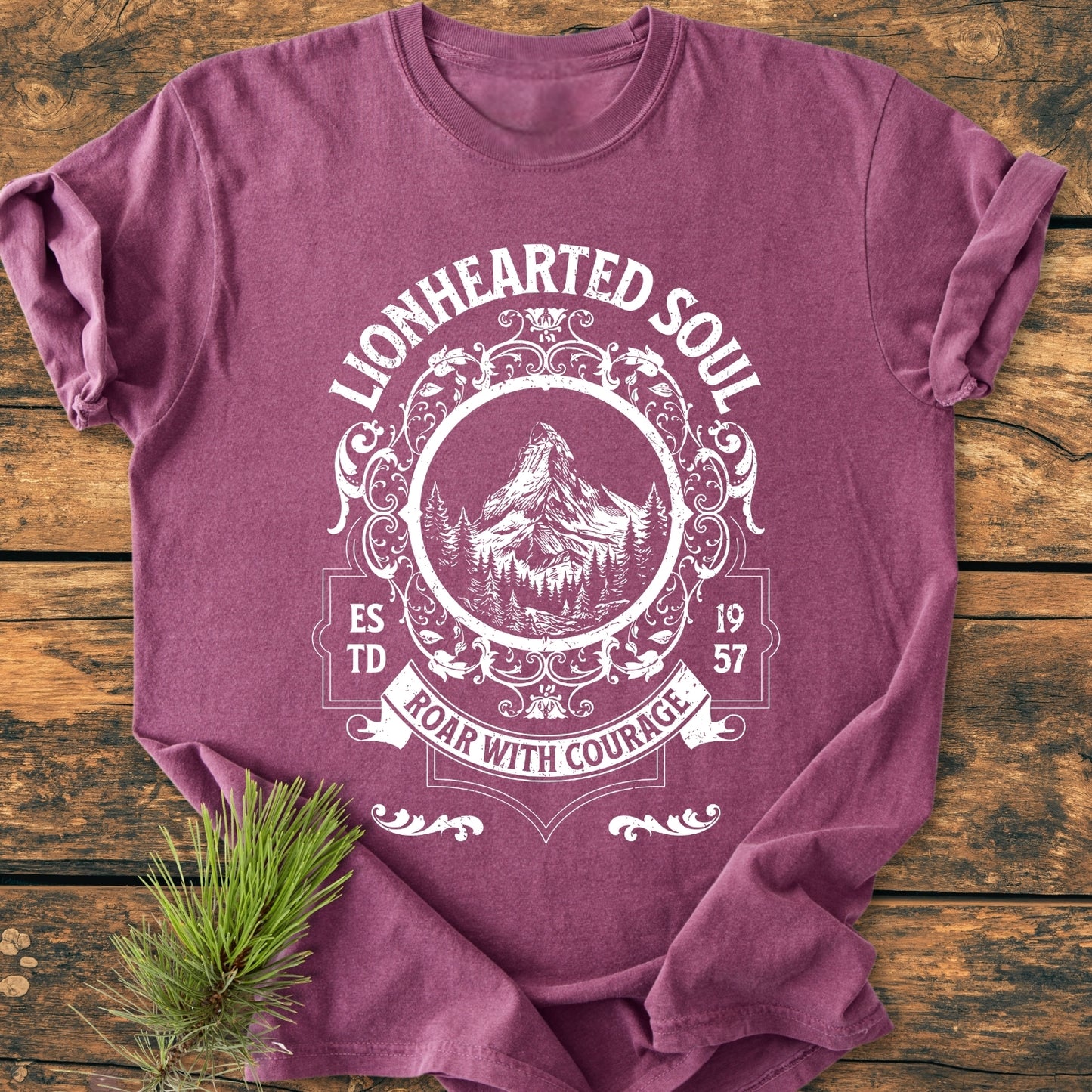 Lionhearted Soul - Vintage Wash Tee displayed flat, featuring a white screen-print with “LIONHEARTED SOUL,” mountain design, “ESTD 1957,” and “ROAR WITH COURAGE” banner on soft-washed plum-purple fabric.