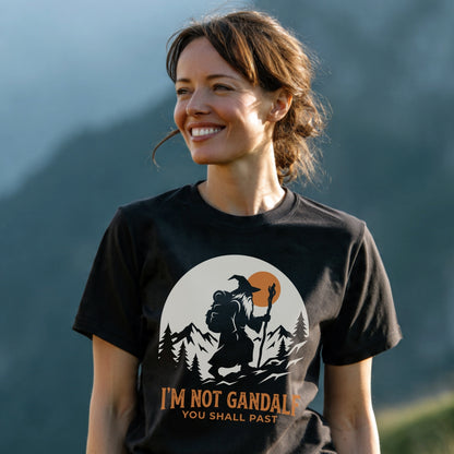 Woman in nature wearing the You Shall Past T-Shirt featuring a wizard graphic and humorous caption, highlighting outdoor adventure spirit.