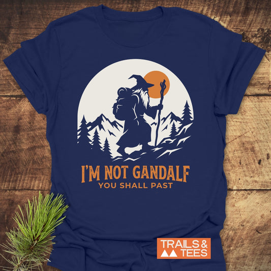 You Shall Past T-Shirt features a bearded wizard silhouette trekking under an orange sun, with “I’M NOT GANDALF — YOU SHALL PAST” slogan, on soft, lightweight ring-spun cotton.