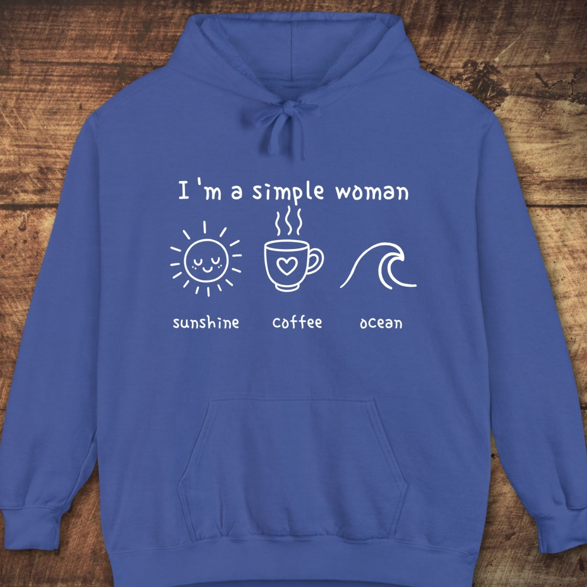 The I'm A Simple Woman - Sunshine Coffee Ocean Hoodie features white line drawings of a sun, coffee mug, and wave on a blue sweatshirt, offering a relaxed unisex fit with a vintage look.