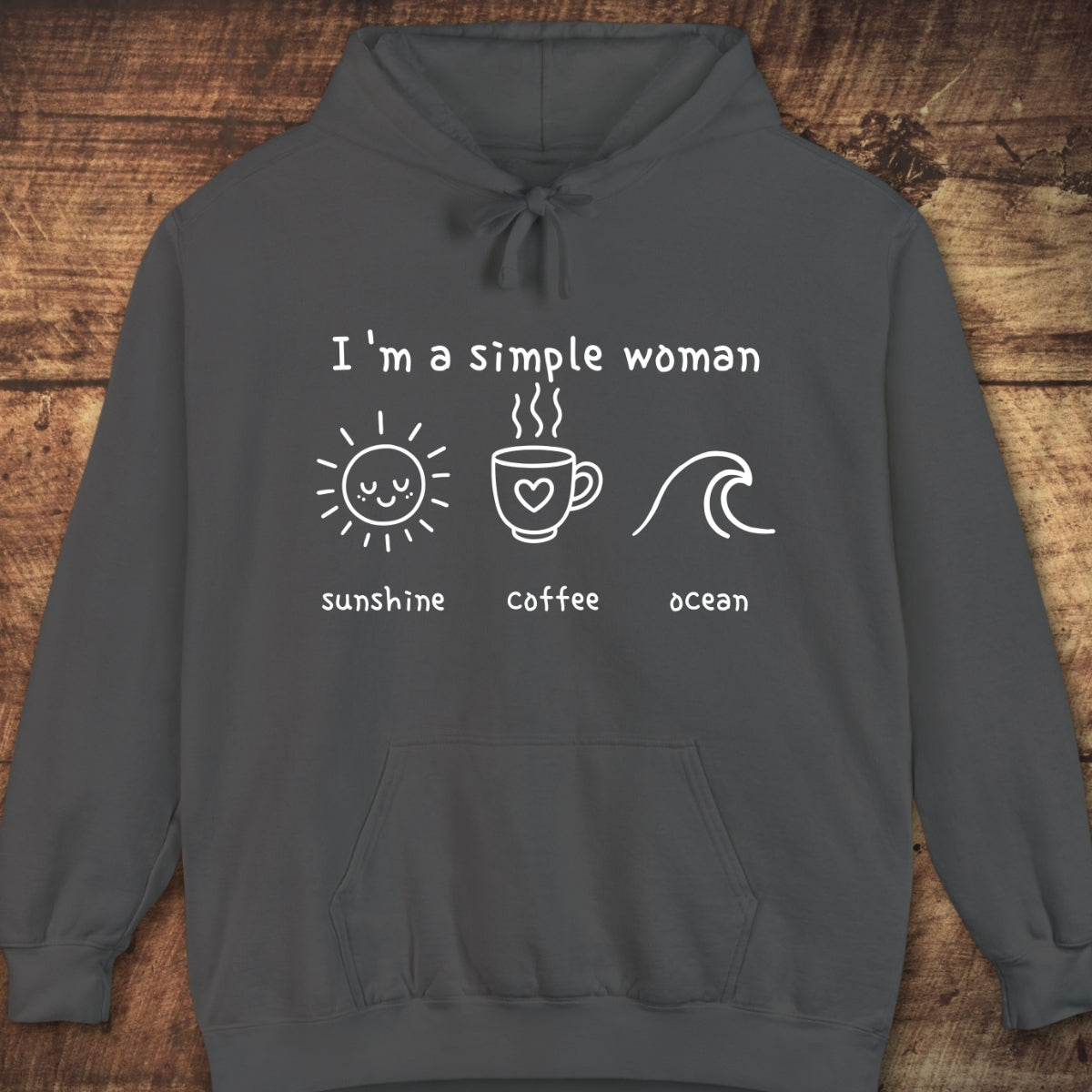I'm A Simple Woman - Sunshine Coffee Ocean Hoodie features a dark-gray pullover with white print icons of a sun, coffee mug, and wave, highlighting its cozy, unisex fit and garment-dyed look.