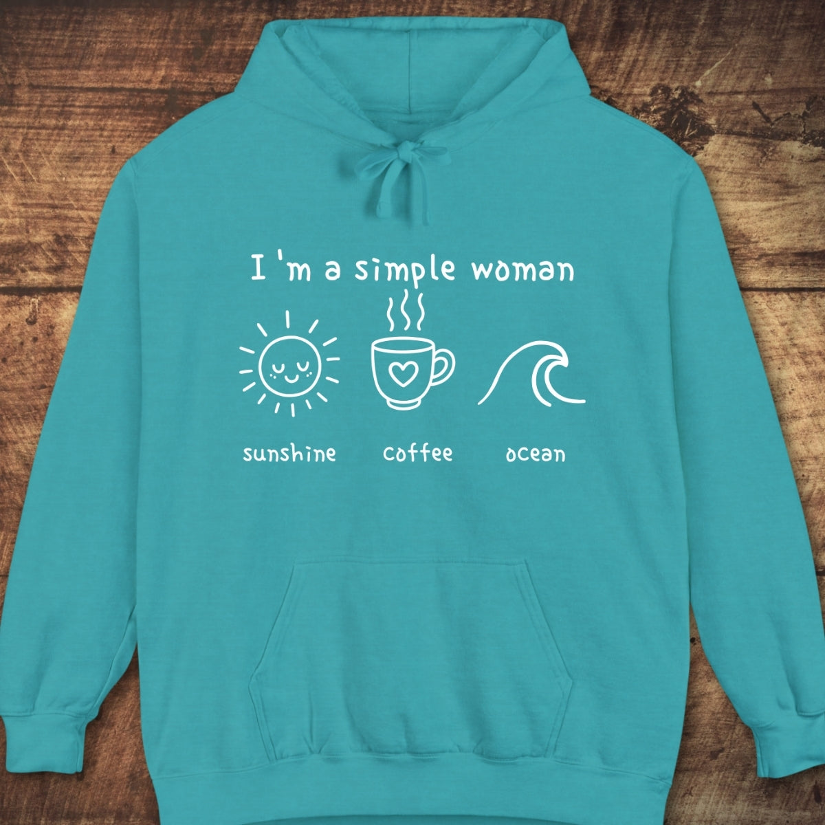 Teal hoodie featuring “I’m a Simple Woman - Sunshine Coffee Ocean” design with icons, laid flat. Made from 80/20 cotton-polyester fleece, showcasing its relaxed, comfortable fit, perfect for casual adventures.