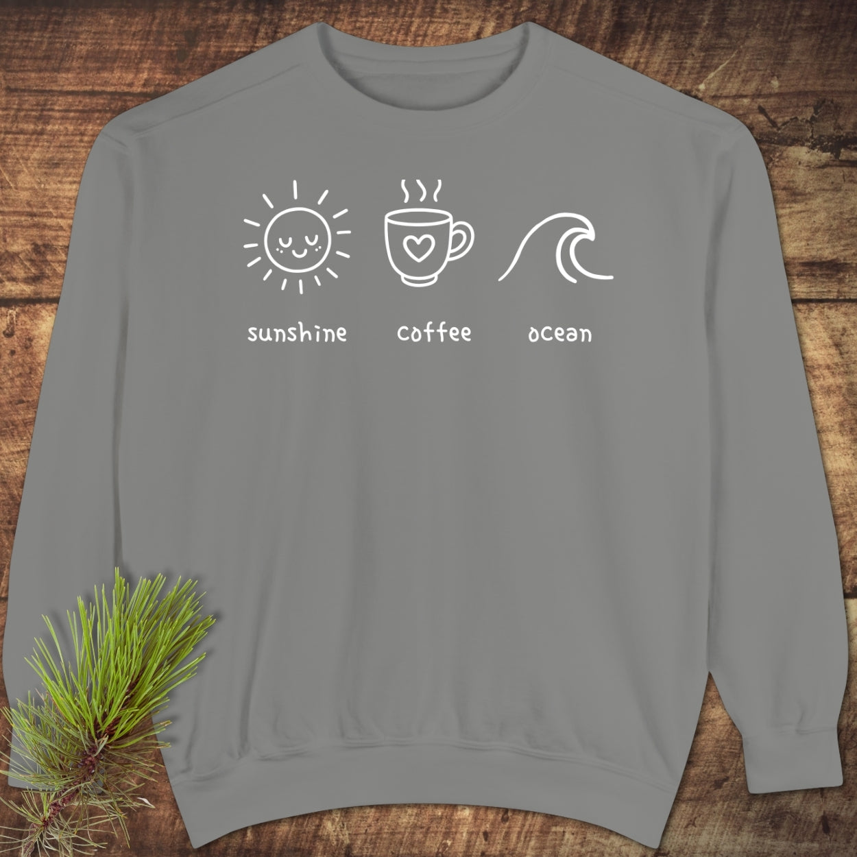 I'm A Simple Woman - Sunshine Coffee Ocean Sweatshirt features a heather-gray crewneck with white line art of a sun, coffee cup, and ocean wave, embodying luxurious comfort and style.