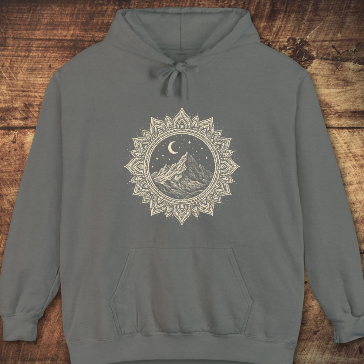 Mountain Mandala Hoodie with front kangaroo pocket and drawstring hood, featuring a mandala-style graphic of a mountain under a crescent moon on a soft, garment-dyed fabric for a relaxed fit.