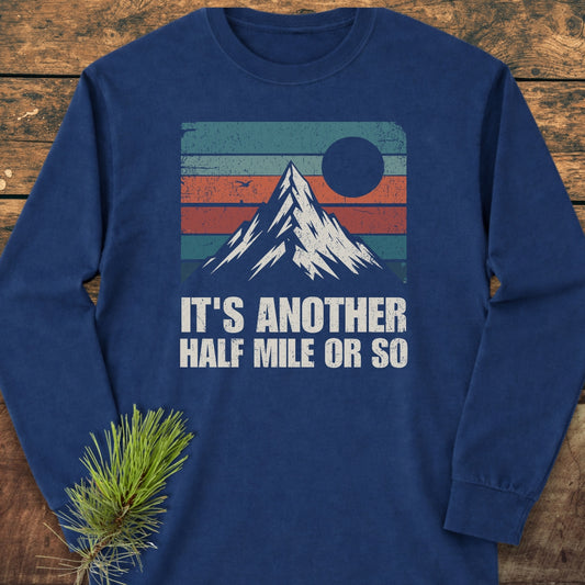 The It's Another Half Mile Or So Long-Sleeve Tee features a retro mountain graphic with teal, orange, and green stripes, a sun, and bird on navy-blue cotton, offering a relaxed, stylish fit.