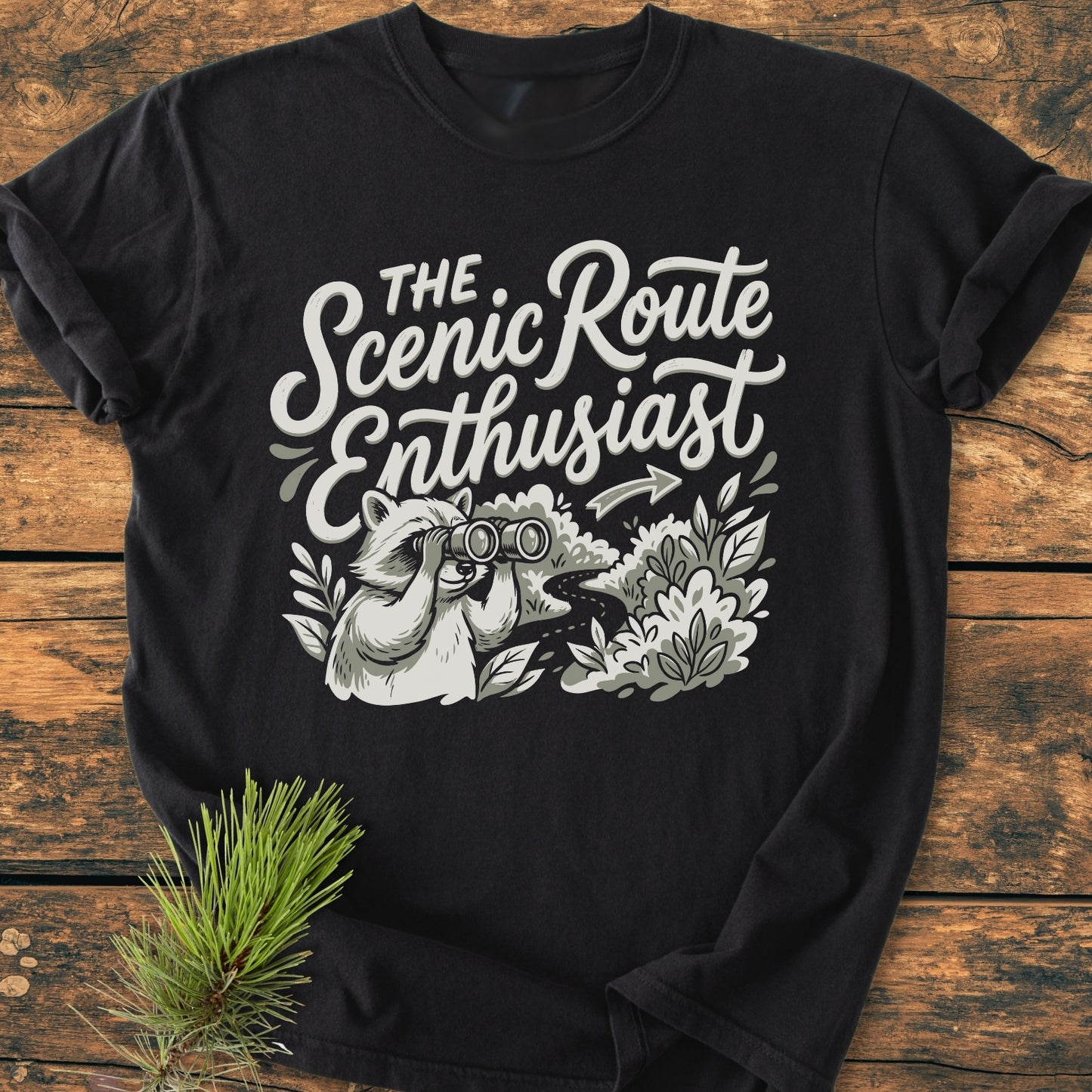 Scenic Route Raccoon - Vintage Wash Tee featuring a playful graphic of a raccoon with binoculars and the slogan “The Scenic Route Enthusiast” on soft, relaxed fit, garment-dyed cotton.
