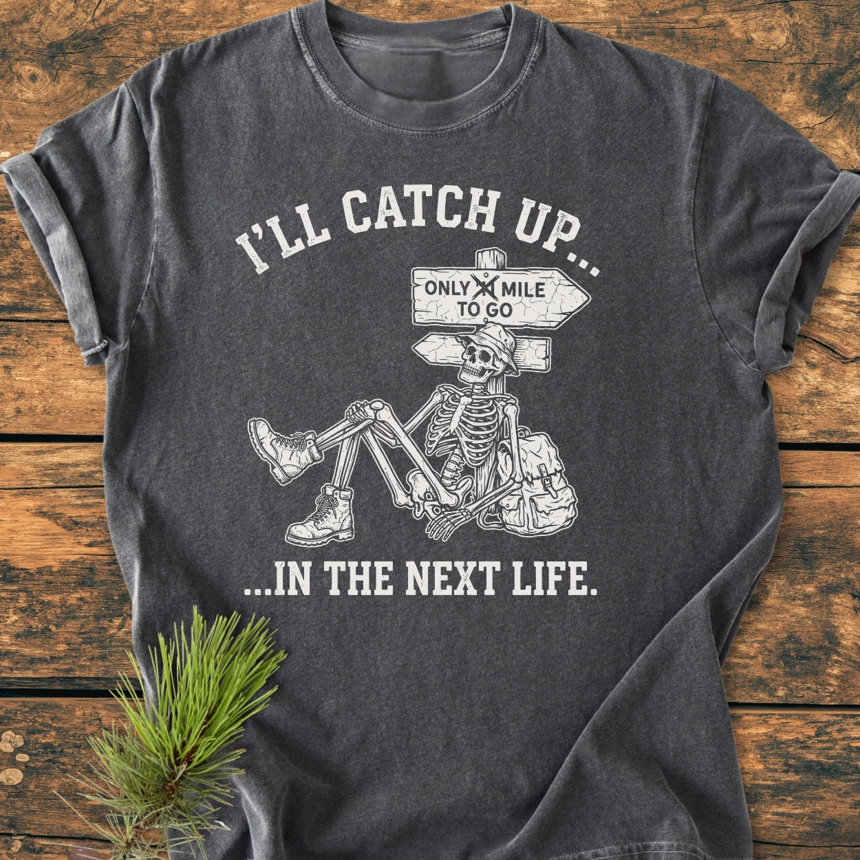I'll Catch Up - Vintage Wash Tee featuring a skeleton in hiking boots, floppy hat, and humorous crossed-out trail sign design, offering comfort with garment-dyed, ring-spun cotton and relaxed fit.