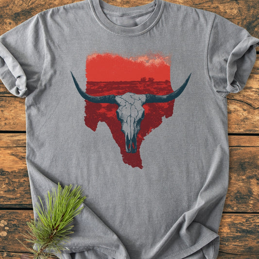 Hike Texas - Vintage Wash Tee: Heather-gray T-shirt with a distressed red Texas outline and cracked longhorn skull graphic, laid on wood. Cozy, relaxed fit with durable double-needle stitching, perfect for everyday wear.