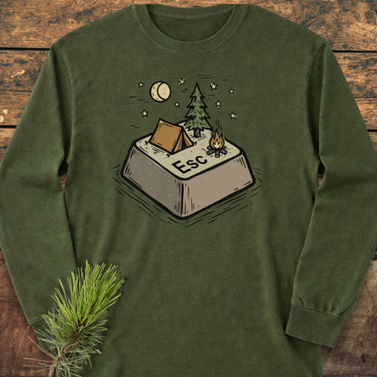 Escape Long-Sleeve Tee featuring a forest-green color with an illustrated ESC key campsite design, complete with a tent, pine tree, campfire, stars, and crescent moon, on a wooden surface.
