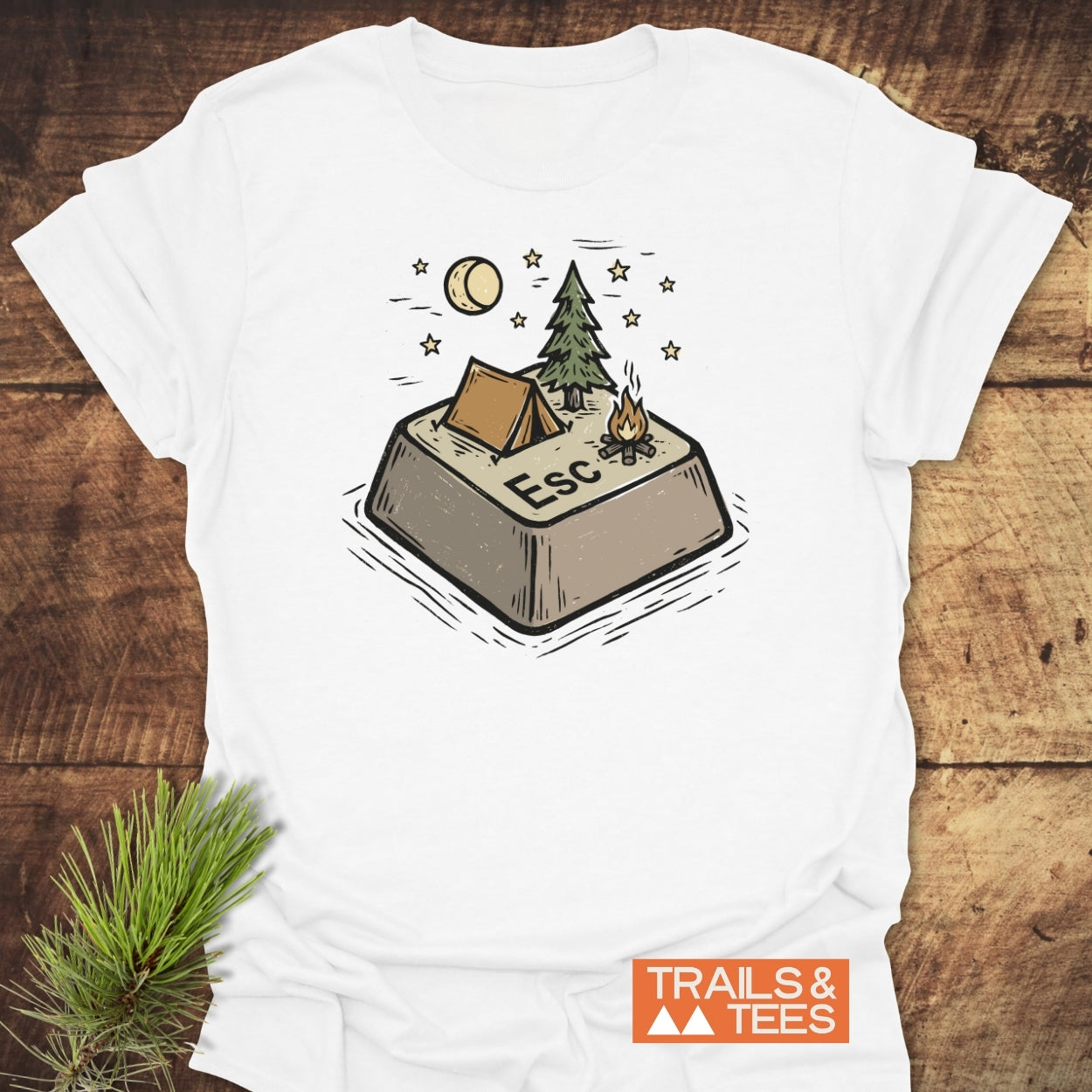 Escape T-Shirt featuring a keyboard Esc key as a campsite with a tent, pine tree, campfire, moon, and stars. Includes TRAILS & TEES logo, crafted for comfort and outdoor enthusiasts.
