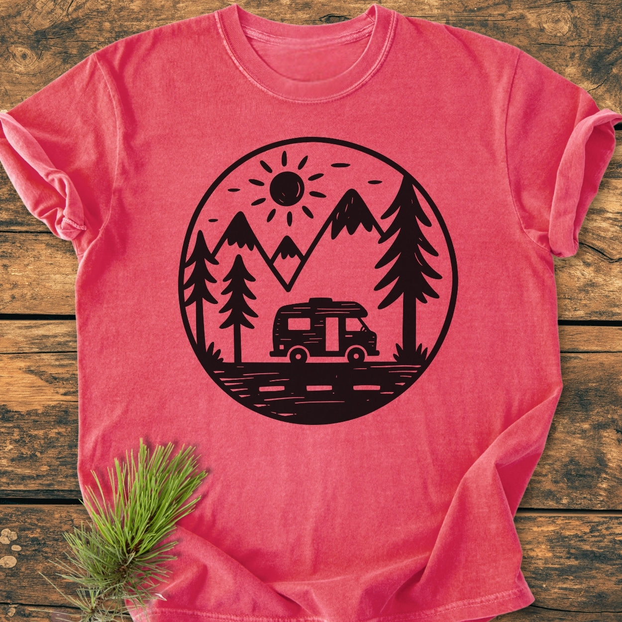 Freedom Is Found Outside - Vintage Wash Tee features a large outdoors graphic with a camper van, pine trees, and mountains, laid on wood, highlighting its relaxed fit and soft-washed, garment-dyed fabric.