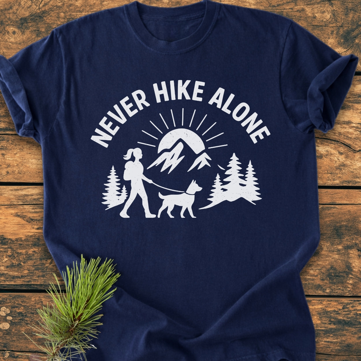 Never Hike Alone Dog Mom - Vintage Wash Tee featuring a white outdoor scene with a hiker and dog. Laid flat, showcasing its relaxed fit and durable double-needle stitching on soft, garment-dyed fabric.
