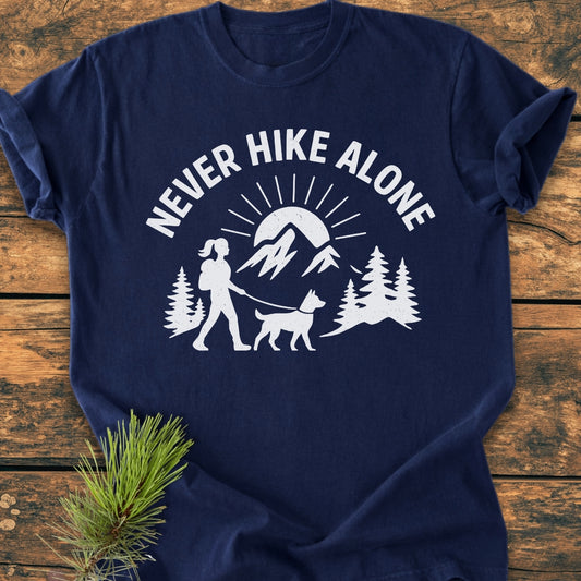 Never Hike Alone Dog Mom - Vintage Wash Tee featuring a white outdoor scene with a hiker and dog. Laid flat, showcasing its relaxed fit and durable double-needle stitching on soft, garment-dyed fabric.