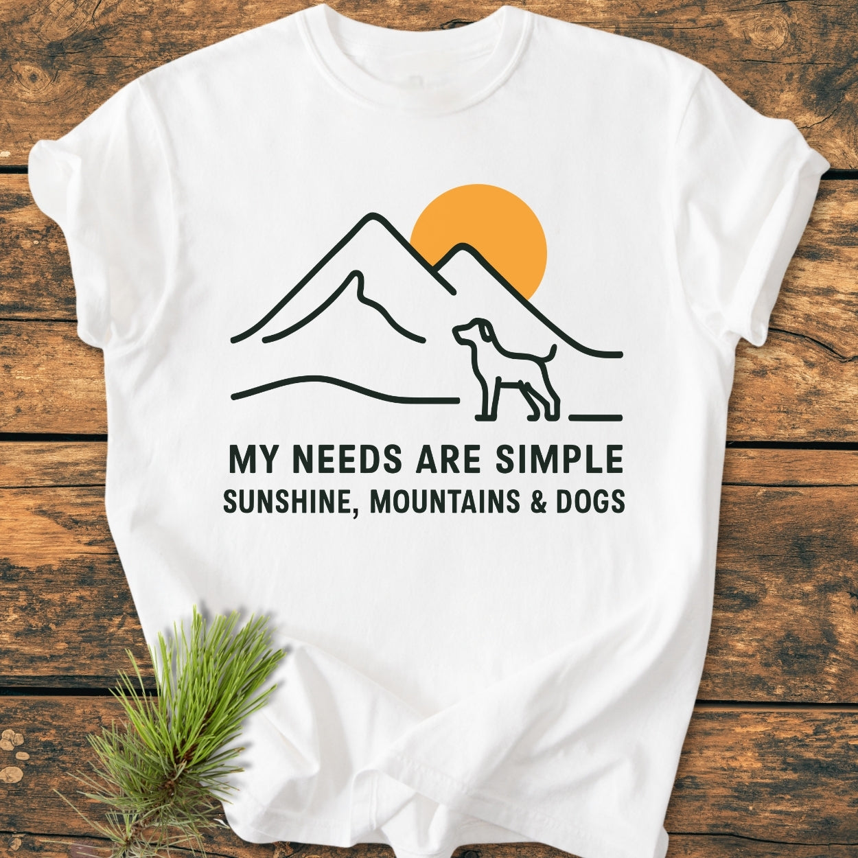 Simple Joys Mountains - Vintage Wash Tee features a minimalist design with mountains, a dog silhouette, and a sunset. The slogan emphasizes simple pleasures. Made of soft, durable ring-spun cotton for comfort.