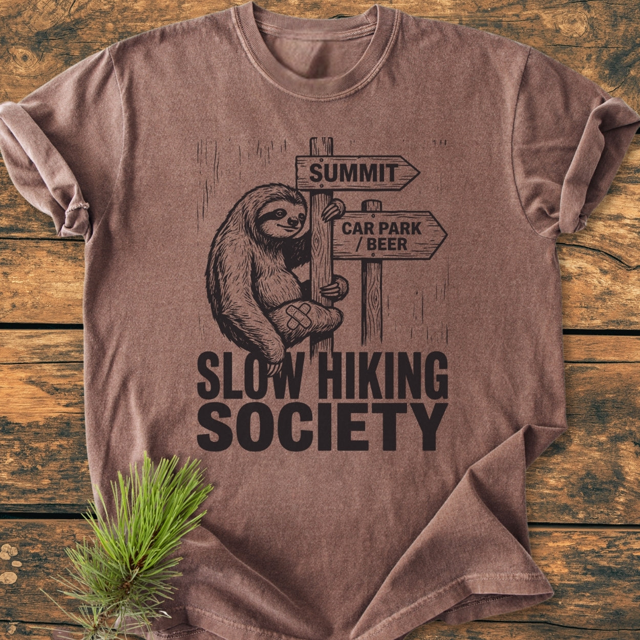 Slow Hiking Society - Vintage Wash Tee features a smiling sloth on a signpost graphic, perfect for relaxed hikes. Made from soft, durable 100% ring-spun cotton for everyday comfort.