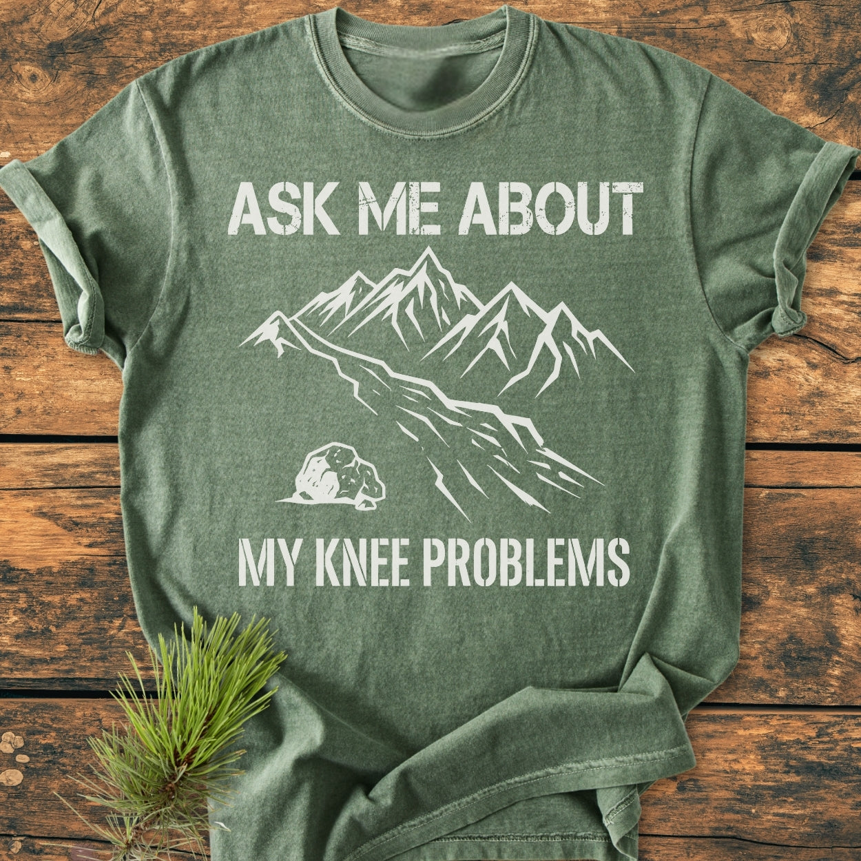 Ask Me About My Knee Problems - Vintage Wash Tee features a stylized mountain range print. This relaxed, medium-weight tee, made of soft-washed, pre-shrunk cotton, offers durability and comfort.