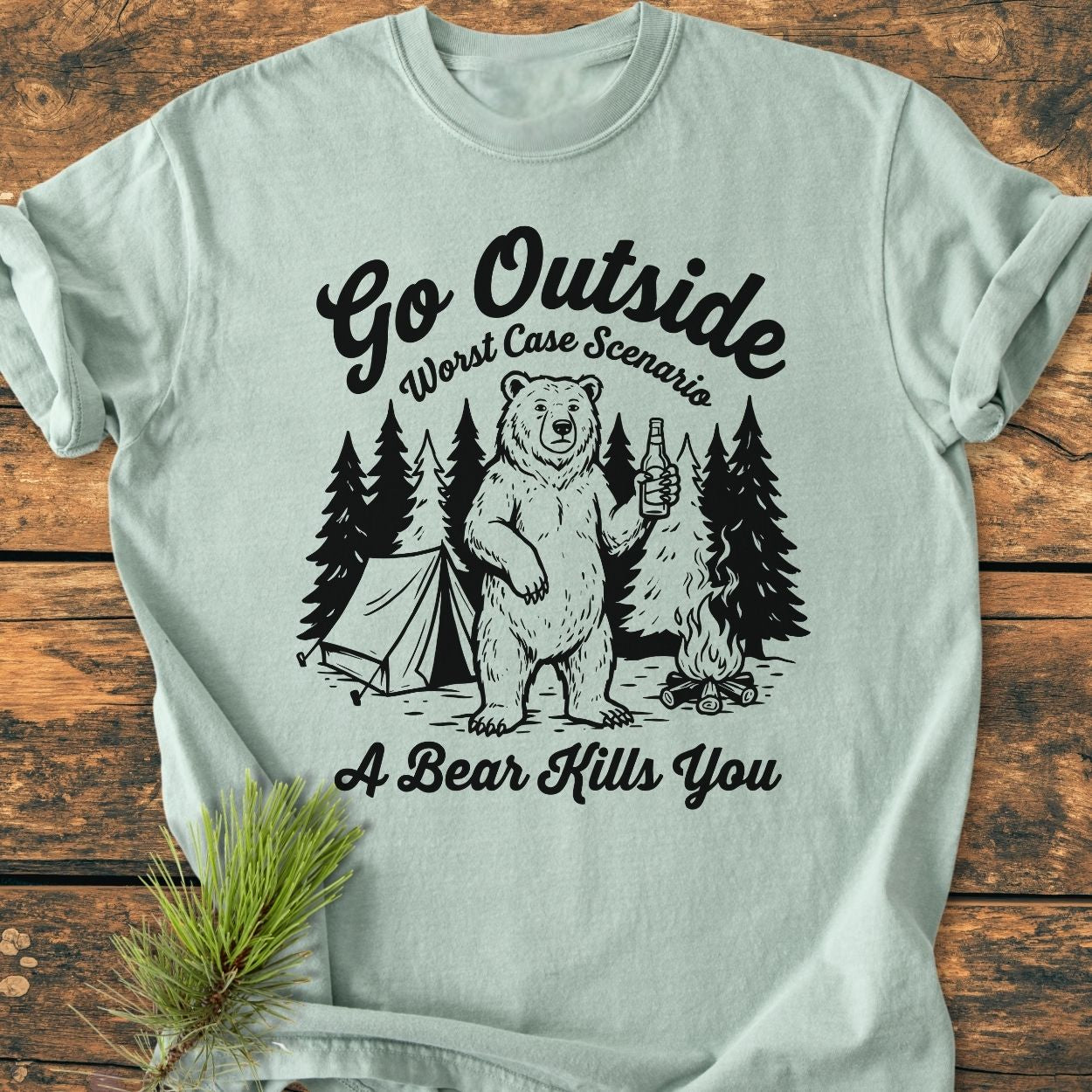 Go Outside - Vintage Wash Tee featuring a cartoon bear with beer, a tent, campfire, and trees. Slogan reads Worst Case Scenario: A Bear Kills You. Made from soft, durable, pre-shrunk cotton.