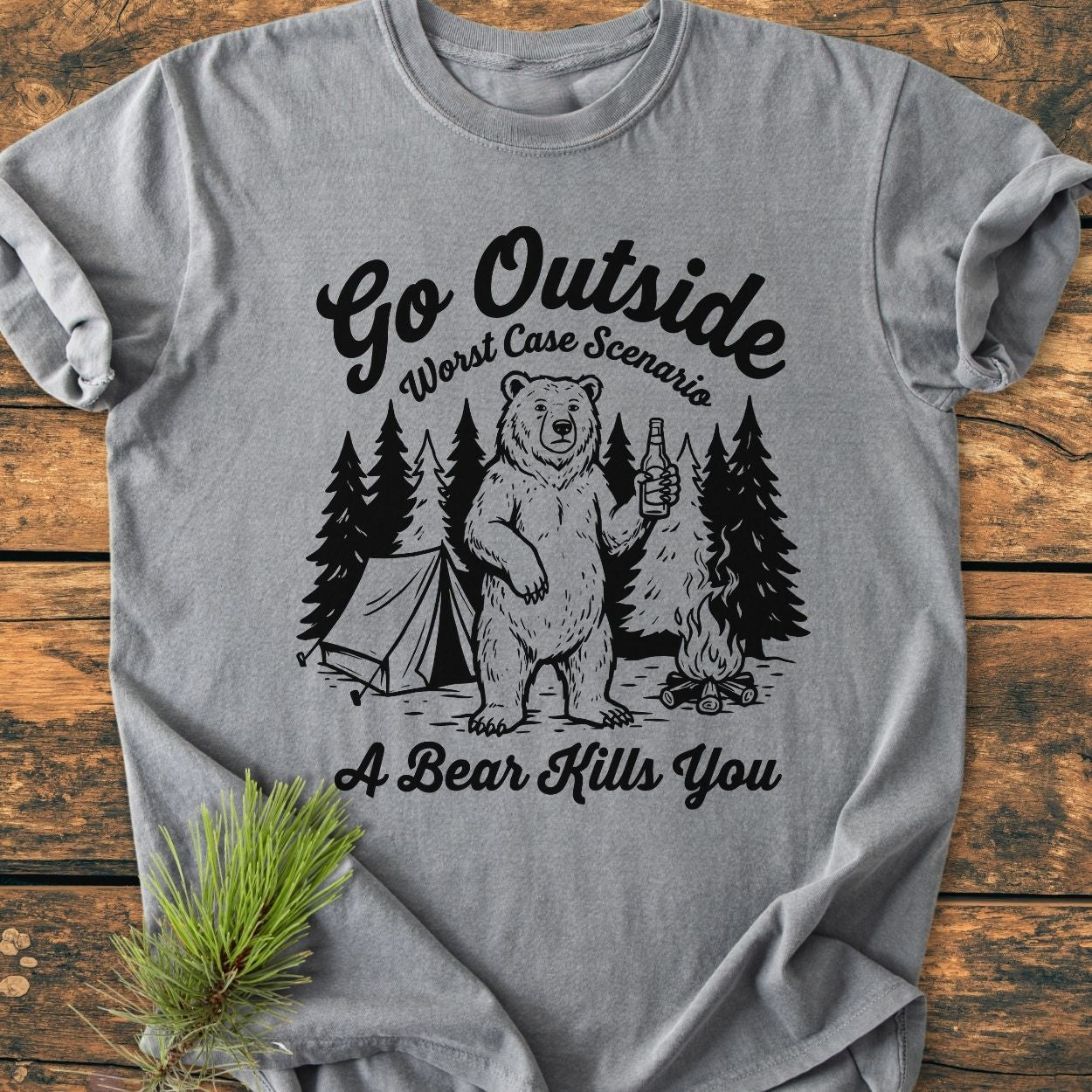 Go Outside - Vintage Wash Tee: Gray T-shirt with camp-themed graphic of a bear, pine trees, tent, and campfire. Text reads 'Go Outside', 'Worst Case Scenario', 'A Bear Kills You.'