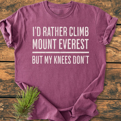 “I’d Rather Climb Mount Everest - Vintage Wash Tee” in heathered plum, displayed flat on wood, with white slogan and pine sprig accent. Soft, relaxed fit, durable, and pre-shrunk for everyday comfort.