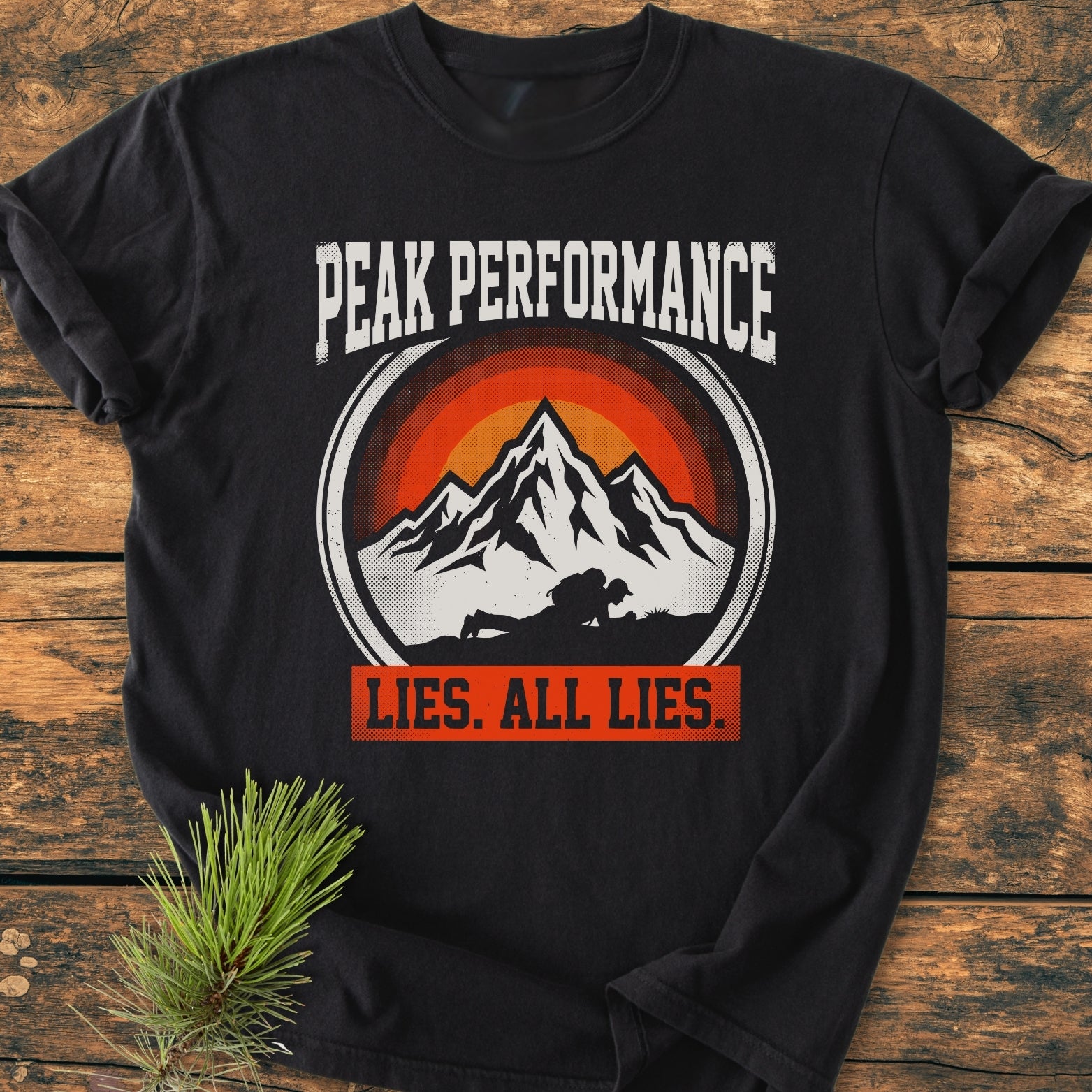 Peak Performance - Vintage Wash Tee features a mountain peak graphic with a sunset and hiker, emphasizing adventure. Crafted from soft 100% cotton, it offers comfort and durability in a relaxed fit.