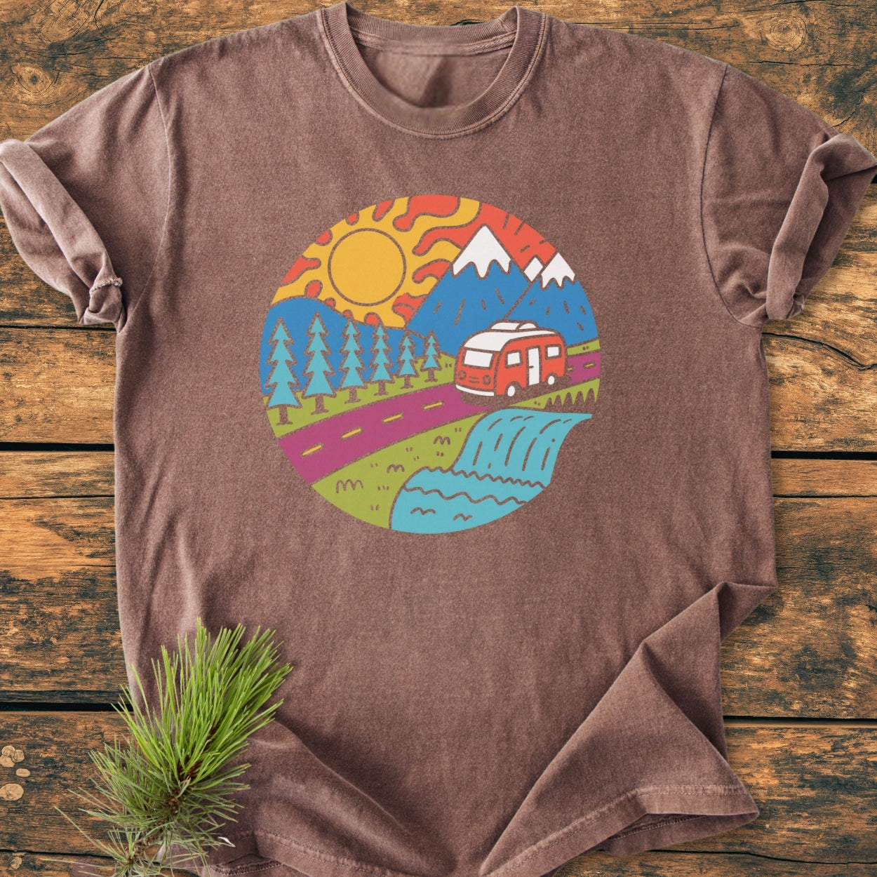 Scenic Route - Vintage Wash Tee: A brown T-shirt featuring a vibrant graphic with a sun, mountains, pine trees, and a camper van, offering a cozy fit and durable, soft-washed fabric.