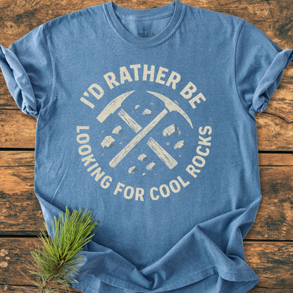 Heather-blue I'd Rather... Rockhound - Vintage Wash Tee with a distressed white graphic of crossed pick-axes and rocks, laid flat, showcasing its relaxed fit and soft garment-dyed fabric.