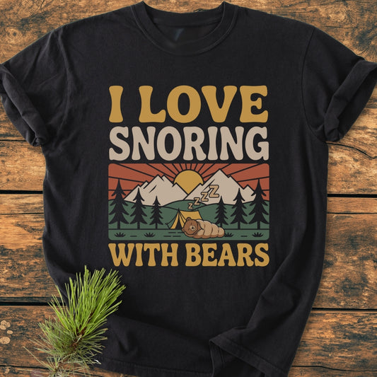I Love Snoring With Bears - Vintage Wash Tee features a nostalgic mountain camping graphic with a cartoon bear asleep, printed on a black, soft-washed, relaxed-fit garment-dyed t-shirt for ultimate comfort.