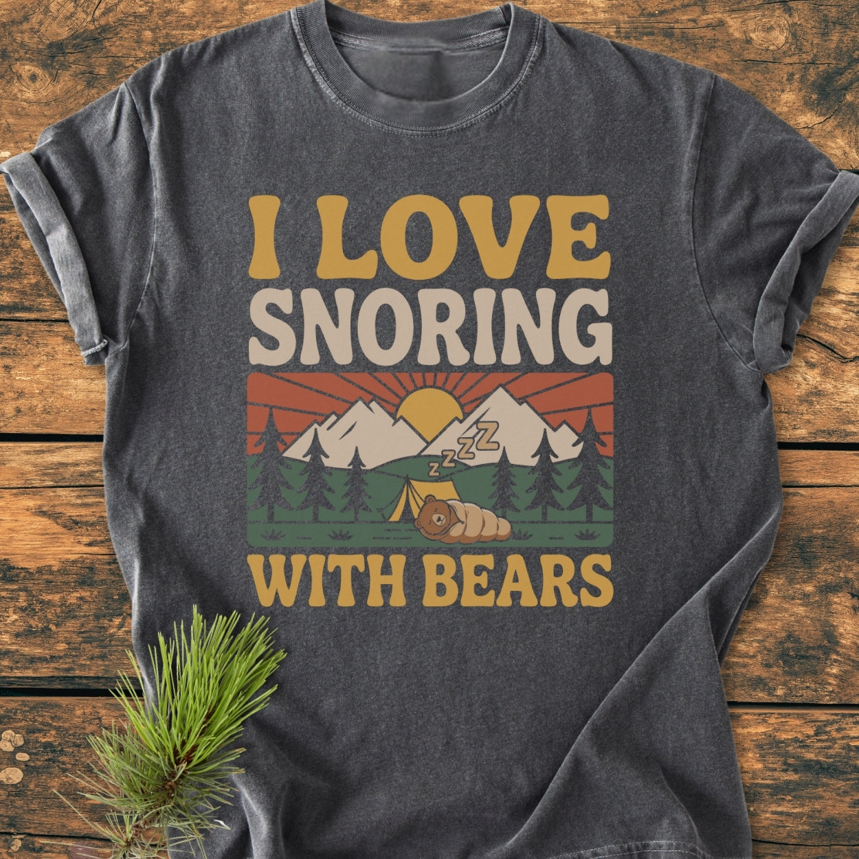 I Love Snoring With Bears - Vintage Wash Tee features a vibrant mountain campsite graphic with a bear sleeping, printed on a dark-gray, soft-washed, garment-dyed T-shirt, ideal for a cozy, relaxed fit.