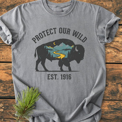 Protect Our Wild - Vintage Wash Tee features a bison silhouette with a wilderness scene, emphasizing nature. Made of soft, durable, pre-shrunk cotton, it offers a relaxed fit for everyday comfort.