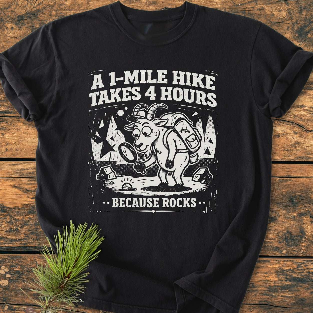 Because Rocks - Vintage Wash Tee featuring a cartoon hiking goat with a backpack and magnifying glass, surrounded by trees and stones, under the slogan 'A 1-Mile Hike Takes 4 Hours...Because Rocks.'