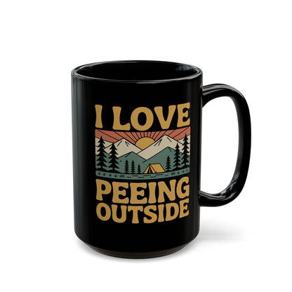 I Love Peeing Outside Ceramic Mug featuring a retro camping scene with pine trees, mountains, a tent, and sun. Black ceramic, glossy finish, available in 11oz and 15oz, dishwasher and microwave safe.