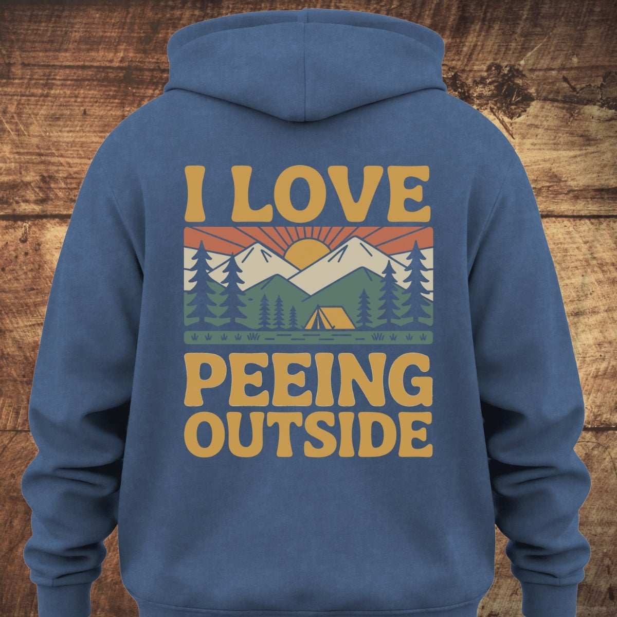 I Love Peeing Outside Hoodie BACKPRINT features a retro outdoors graphic with a sunrise, mountains, pine trees, and a tent, showcasing the bold slogan for a playful, adventurous vibe.