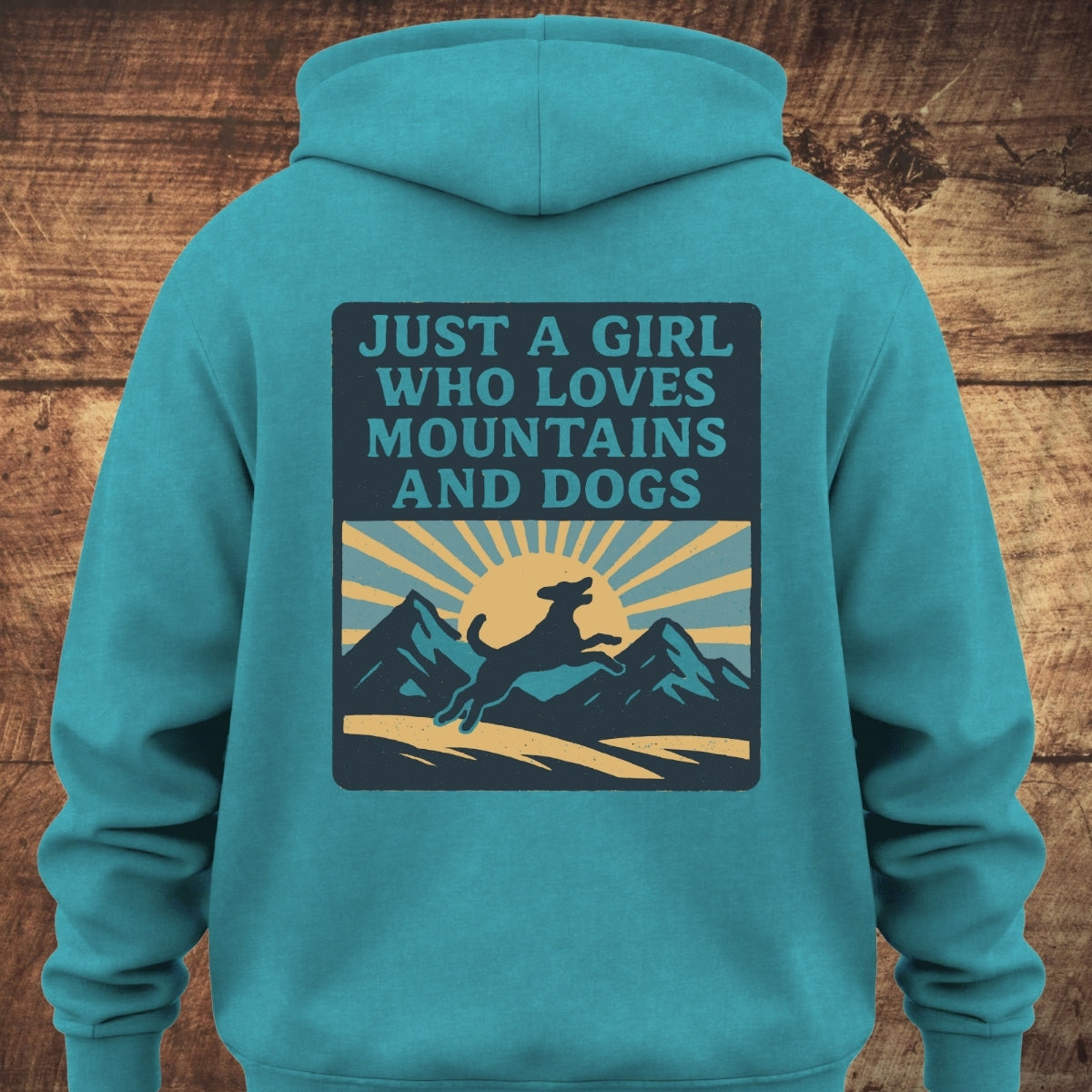 Back view of the Just A Girl Who Loves Dogs Hoodie BACKPRINT featuring a mountain scene with a leaping dog silhouette, designed for cozy comfort with a relaxed fit and garment-dyed texture.
