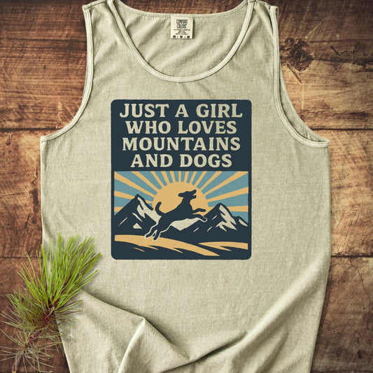 Just A Girl Who Loves Dogs Tank Top features a bold graphic with a dog, mountains, and sun. Made from ring-spun US cotton, it offers a relaxed fit and eco-friendly vibrant dyes.