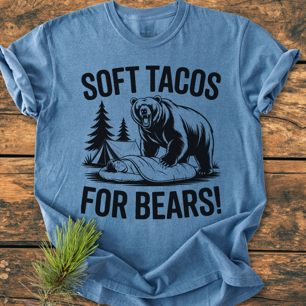 Soft Tacos For Bears - Vintage Wash Tee showcases a campsite scene with a bear near a sleeper. This heather-blue Comfort Colors shirt offers a relaxed fit and durable cotton fabric.