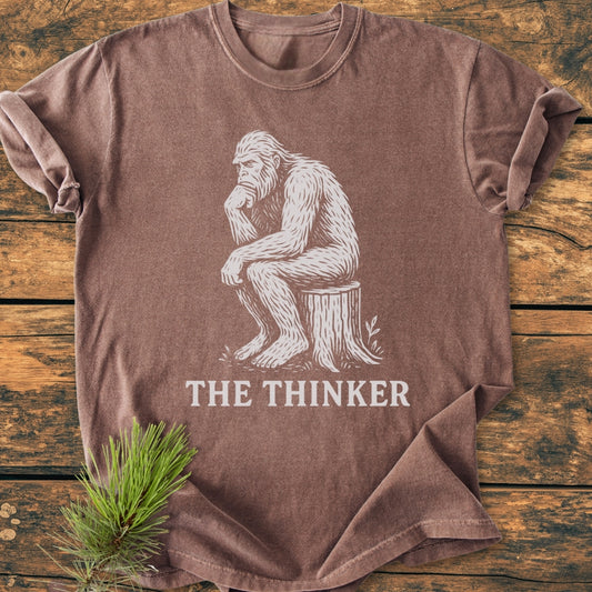 Bigfoot The Thinker - Vintage Wash Tee with a white Sasquatch in Thinker pose on rustic wood, featuring durable, pre-shrunk, 100% ring-spun cotton for comfort and relaxed fit.