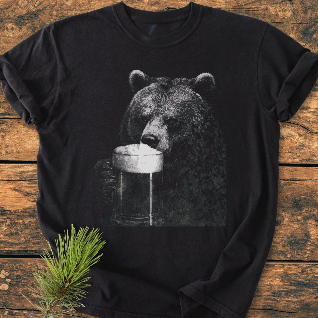 Grizzly With Beer - Vintage Wash Tee featuring a grayscale bear sipping beer, laid flat on wood. Crafted from 100% ring-spun cotton, this relaxed fit tee offers durability and comfort.