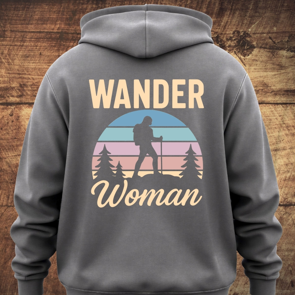 Wander Woman Retro Hoodie BACKPRINT features WANDER and Woman text with a circular graphic of a silhouetted backpacking woman, capturing an adventurous spirit on a cozy, garment-dyed sweatshirt.