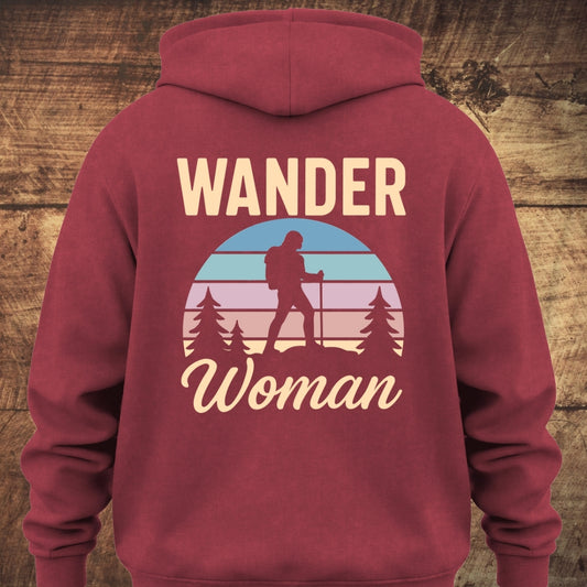 Back view of the Wander Woman Retro Hoodie BACKPRINT, featuring a circular sunset scene with pine trees and a woman hiker silhouette, surrounded by the words “WANDER Woman.” Perfect for trail mornings and cozy nights.