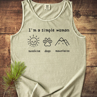 I'm A Simple Woman - Sunshine, Dogs, Mountains Tank Top laid flat, showcasing black line drawings of a sun, dog paw, and mountains, highlighting its relaxed fit and eco-friendly, ring-spun US cotton fabric.