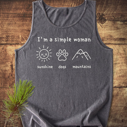I'm A Simple Woman - Sunshine, Dogs, Mountains Tank Top: Heather-grey tank top with icons of a sun, dog paw, and mountains, labeled accordingly, laid on wood with a pine sprig beside it.